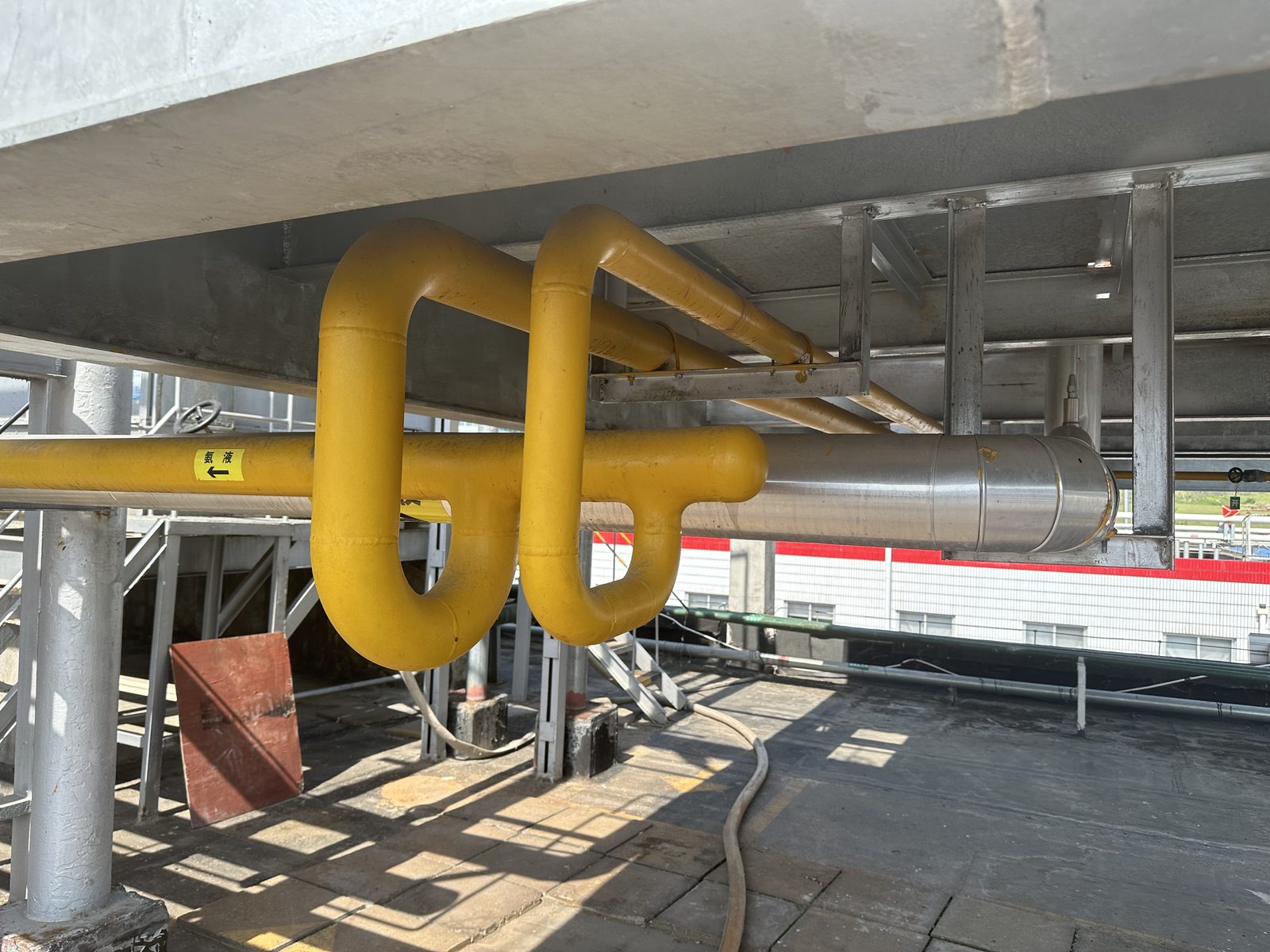 Insulated and color-coded liquid drain / process piping under a platform